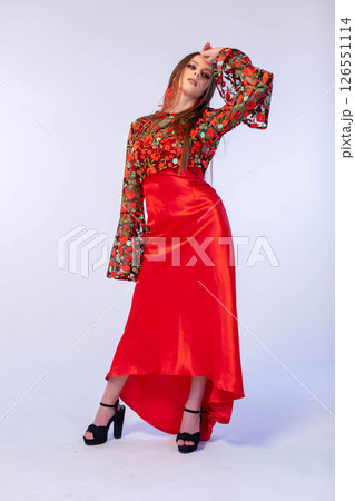 An Elegant Fashion Model Striking a Pose in a Beautiful and Colorful Dress Ensemble 126551114