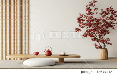 A minimalist room with Japanese-inspired decor features a low wooden table, a tea set, and potted plants. Shoji screens allow soft natural light to fill the space. 126551421