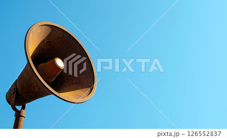 Old Megaphone Against a Bright Blue Sky, Capturing Attention in a Sunny Outdoor Setting 126552837