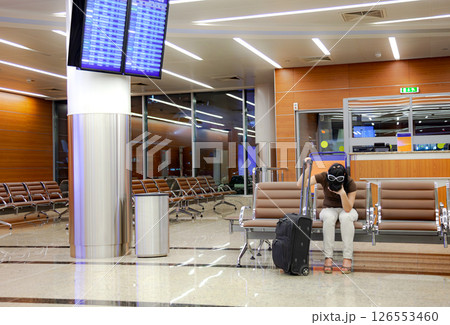 Woman was late for a plane or train flight or it was canceled. 126553460
