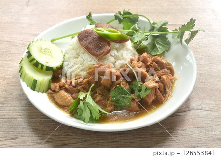 steamed chicken in salty gravy sauce dressing rice with chili and cucumber in plate 126553841