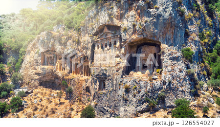 The ancient ruins of Myrna city close to Antalya Turkey, with creepy rock tombs lightened by sun going down. 126554027