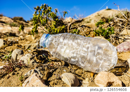 Plastic empty water bottle abandoned on nature 126554608