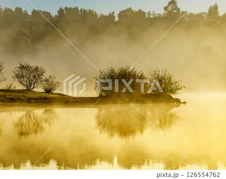 Morning fog over autumn lake water 126554762