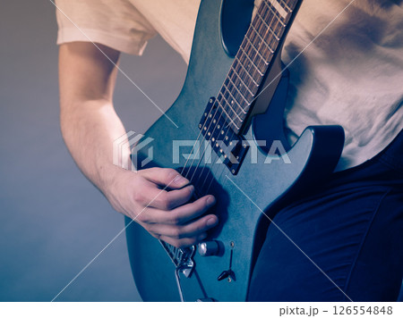 Close up of man playing on electric guitar Close up of man playing on electric guitar 126554848