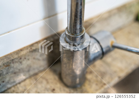 Dirty kitchen sink faucet contaminated with calcium and dirt. 126555352