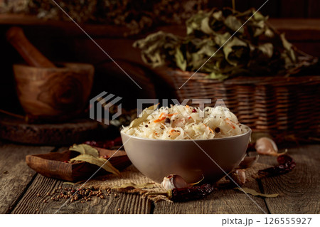 Traditional German sauerkraut on a old rustic wooden table. Traditional German sauerkraut on a old rustic wooden table. 126555927
