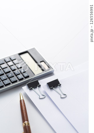 クリップで挟んだ資料と電卓 126556991