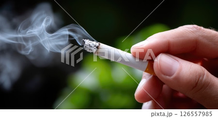 Close-up of Cigarette Smoke Highlighting Smoking Risks Close-up of Cigarette Smoke Highlighting Smoking Risks 126557985