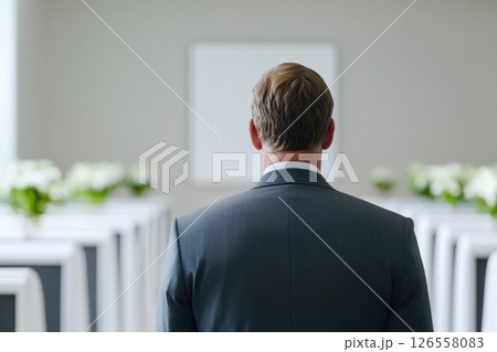 Man in Suit Facing a Serene Indoor Ceremony Space Man in Suit Facing a Serene Indoor Ceremony Space 126558083