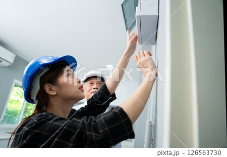 Senior home inspector checking home defects and teaching young engineers, before handing it over to client. Young engineers learn home inspection with Senior, Real estate, and renovation concepts. 126563730