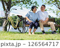 Happy and healthy couple Asian sitting chair beside a bicycle Family and friendship lifestyle, Enjoyment of active seniors, and outdoor activity after retirement, health care insurance concept 126564717