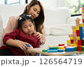 Cherry young mother plays colorful toy block with her Down syndrome daughter,  colorful wooden toys can increase skills and learning to increase the development, special education, Knowing slowly 126564719