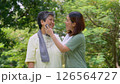 Attractive Senior mother and daughter working out together in the morning exercise in the park. Daughter absorbs sweat from her mom with white towel, a senior caregiver, and a happy family concept. 126564727