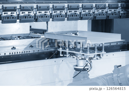 High technology bending machine operation with robotic system in the light blue scene. High technology bending machine operation with robotic system in the light blue scene. 126564815