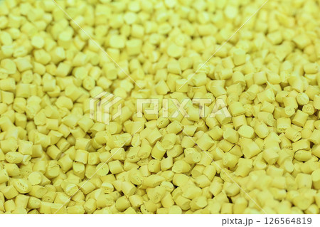 The pile of yellow pellets materials for plastic injection process. 126564819