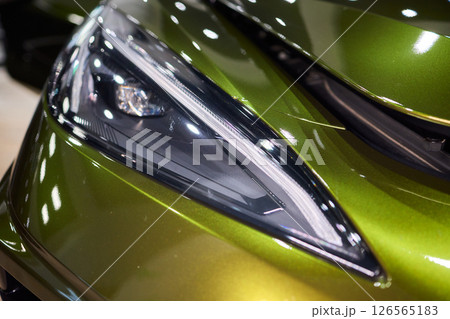 Close up of a cars headlight, part of automotive design Close up of a cars headlight, part of automotive design 126565183