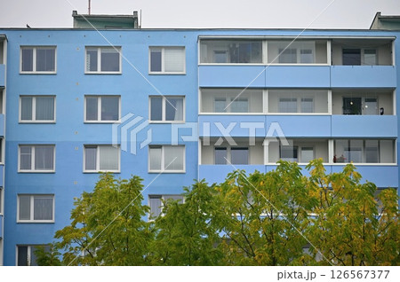 Original prefabricated houses on a housing estate from the communist era in Eastern and Central Europe after reconstruction.. Facade of a modern apartment building with windows and balconies. Czech Original prefabricated houses on a housing estate from the communist era in Eastern and Central Europe after reconstruction.. Facade of a modern apartment building with windows and balconies. Czech 126567377