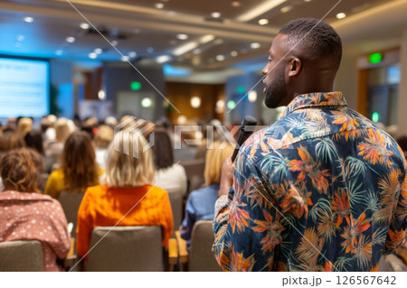 Man preparing to speak during Q&A session at corporate event 126567642