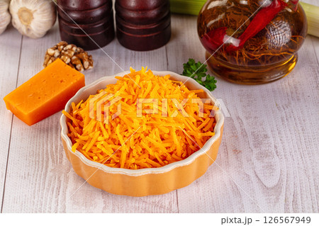 Yellow shredded cheddar cheese in the bowl 126567949