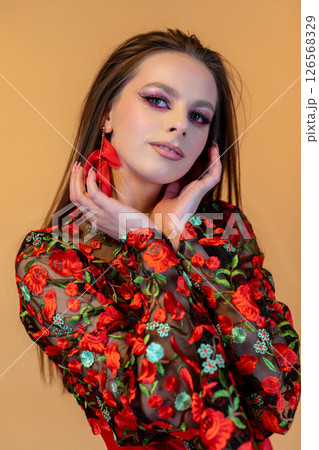 A Vibrant Fashion Portrait Featuring Floral Elegance and Bold, Striking Makeup Choices 126568329