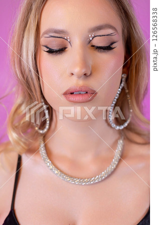 A Stunning Glamorous Beauty Portrait Featuring Sparkling Glitter Makeup and Elegant Jewelry A Stunning Glamorous Beauty Portrait Featuring Sparkling Glitter Makeup and Elegant Jewelry 126568338