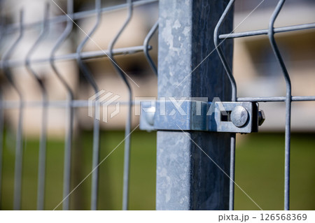 Detailed CloseUp of a Metal Fence Junction along with its Support Structure Components 126568369