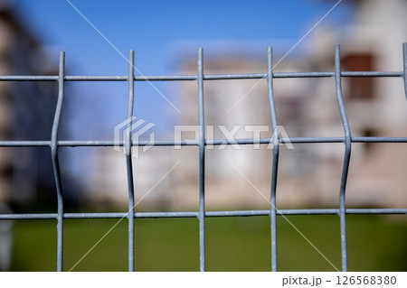 A CloseUp View of a Wire Mesh Fence Framed by a Beautifully Blurred Background Scene A CloseUp View of a Wire Mesh Fence Framed by a Beautifully Blurred Background Scene 126568380