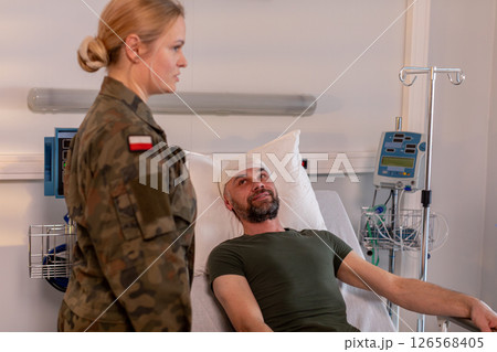 Military Personnel Visiting and Supporting Injured Soldier at the Hospital During Recovery 126568405