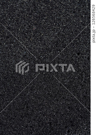 Background of porous foam rubber. Black foam rubber. Packaging material. 126568429