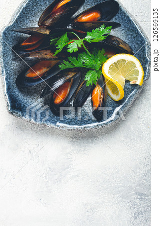 mussels in shells, boiled in their own juice, in a bowl, gray background, top view, homemade , no people, mussels in shells, boiled in their own juice, in a bowl, gray background, top view, homemade , no people, 126569135