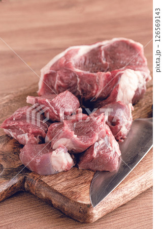 raw beef meat, sliced on a cutting board, with a knife, no spices, no herbs, top view, wooden table, homemade, no people, raw beef meat, sliced on a cutting board, with a knife, no spices, no herbs, top view, wooden table, homemade, no people, 126569143