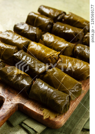 dolma, minced meat with rice, in grape leaves, minced meat rolls, on a chopping board, top view, no people, dolma, minced meat with rice, in grape leaves, minced meat rolls, on a chopping board, top view, no people, 126569177