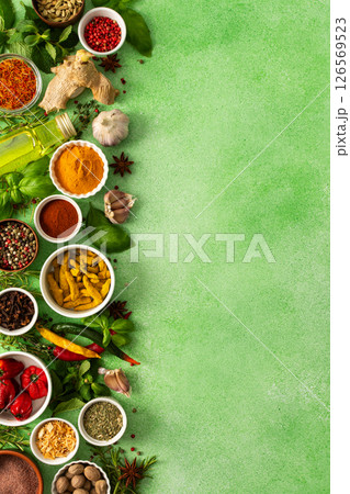 Fresh, fragrant spices and herbs arranged in an array of colors, sitting on a soft green backdrop, bringing flavor and zest to any kitchen, top view and copy space Fresh, fragrant spices and herbs arranged in an array of colors, sitting on a soft green backdrop, bringing flavor and zest to any kitchen, top view and copy space 126569523