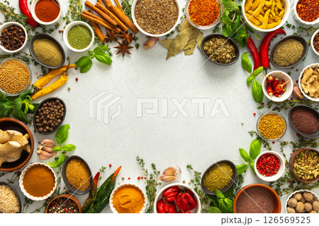Fresh and colorful spices and herbs arranged in a frame on a gray background, adding natural beauty and culinary charm, top view and copy space Fresh and colorful spices and herbs arranged in a frame on a gray background, adding natural beauty and culinary charm, top view and copy space 126569525