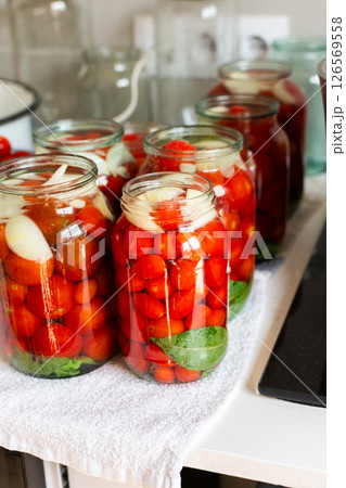 Preserving fresh tomatoes and tomato juice for the winter, stored in airtight jars for long-term use Preserving fresh tomatoes and tomato juice for the winter, stored in airtight jars for long-term use 126569558