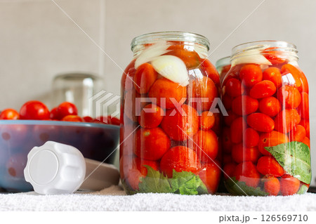 Homemade tomato preserves and tomato juice, canned and sealed for winter storage, maintaining flavor and freshness Homemade tomato preserves and tomato juice, canned and sealed for winter storage, maintaining flavor and freshness 126569710