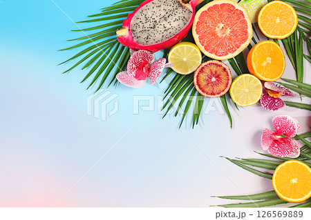 Dragon fruit, pitaya, oranges, lemons, orchid flowers on palm leaves, tropical background with palm trees and exotic fruits, beautiful template for your design, bright banner, summer in a snapshot. Dragon fruit, pitaya, oranges, lemons, orchid flowers on palm leaves, tropical background with palm trees and exotic fruits, beautiful template for your design, bright banner, summer in a snapshot. 126569889