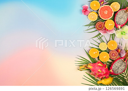 Summer in a snapshot. Dragon fruit, pitaya, oranges, lemons, orchid flowers on palm leaves, Tropical background with palm trees and exotic fruits, beautiful template for your design, sunny banner, 126569891