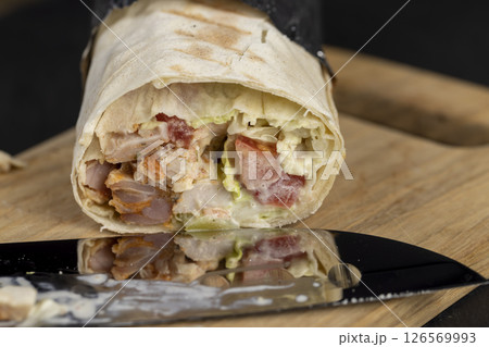 fast food shawarma made from various ingredients packed in foil 126569993
