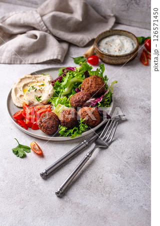 Salad with hummus, falafel and vegetables Salad with hummus, falafel and vegetables 126571450