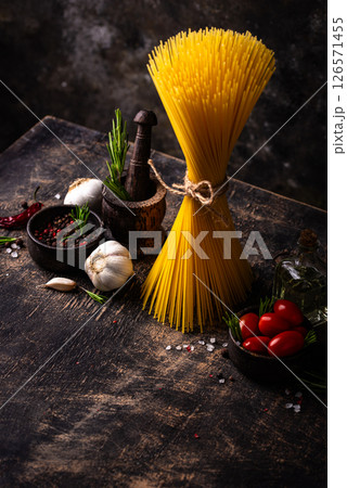 Italian food background with spaghetti, tomato and spices Italian food background with spaghetti, tomato and spices 126571455