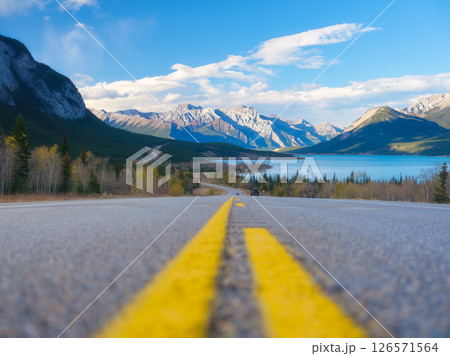 Asphalt road. High mountains on the horizon. The direction of travel. Asphalt road. High mountains on the horizon. The direction of travel. 126571564