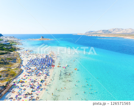 Beach La Pelosa, Sardinia, Italy. Summer vacation and rest. Beach, people and umbrellas. Beach La Pelosa, Sardinia, Italy. Summer vacation and rest. Beach, people and umbrellas. 126571565