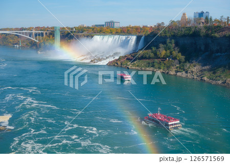 Niagara Falls. A pleasure boat with people near the huge famous waterfall.  126571569