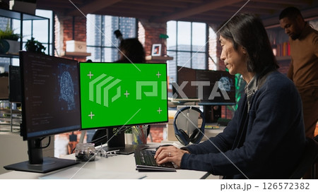 AI startup office chief technology officer building application on isolated screen computer. Senior developer working in artificial intelligence software development agency on mockup PC, camera A 126572382