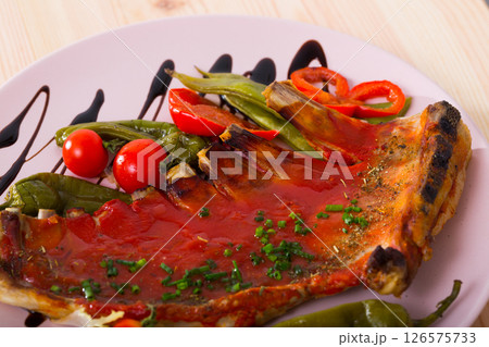 Mutton ribs baked under hot tomato sauce 126575733