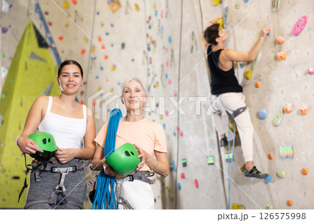 two active female marathon participants are standing in climbing hall two active female marathon participants are standing in climbing hall 126575998