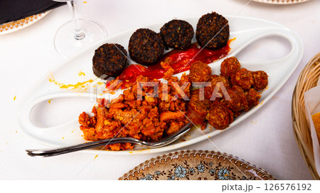 Blood sausage, chorizo, picadillo and roasted peppers 126576192