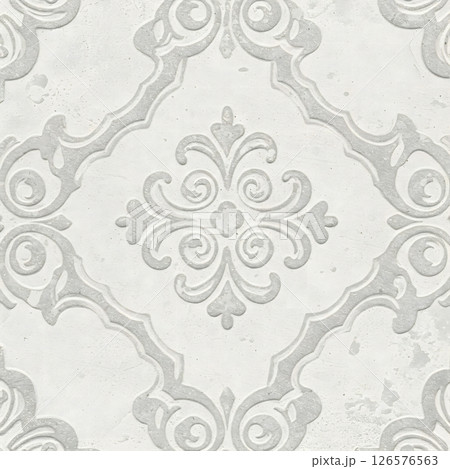 A light gray surface features a repeating ornate raised pattern with floral and scroll elements A light gray surface features a repeating ornate raised pattern with floral and scroll elements 126576563